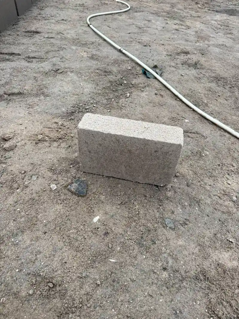 A single Naydo Keystone cement brick on site