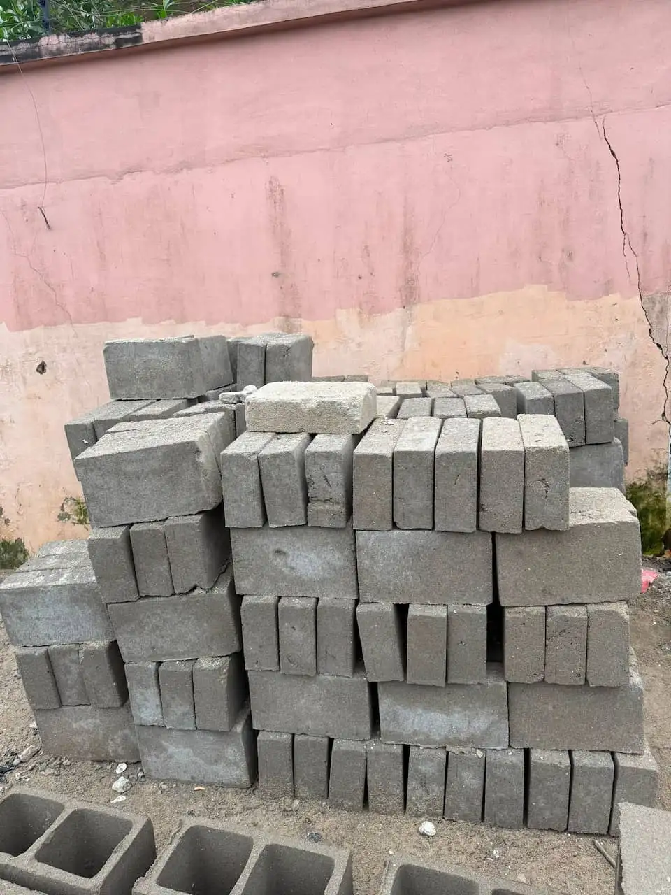 Solid concrete blocks stacked and ready for collection at the yard